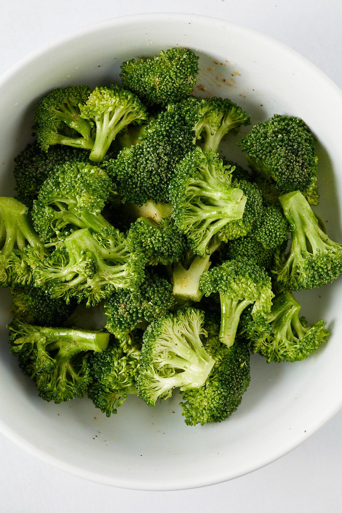 Broccoli florets tossed in oil and seasonings.