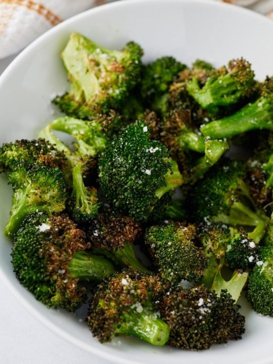 Air fryer broccoli served in a white bowl.