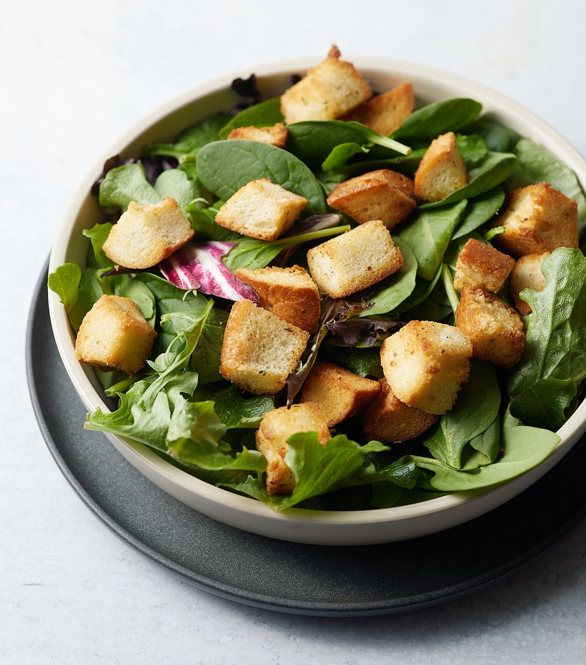 Croutons served on top of a green salad.