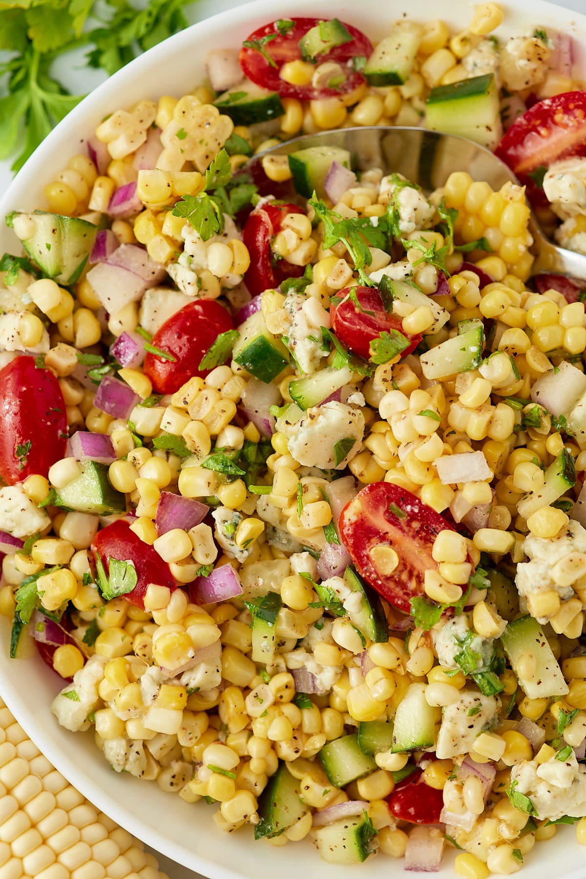 Corn salad with fresh vegetables in a bowl.