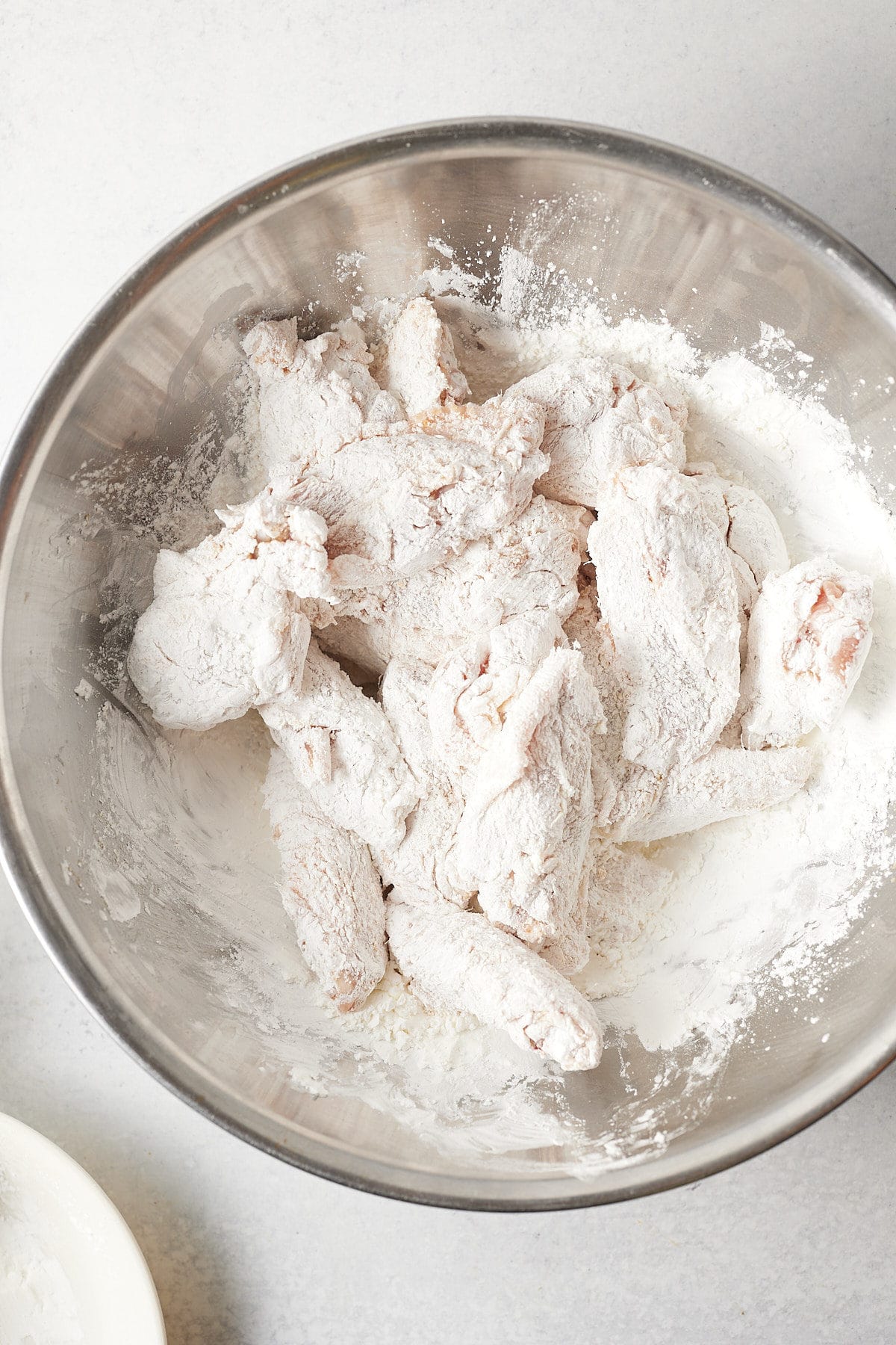 Wings tossed in cornstarch.