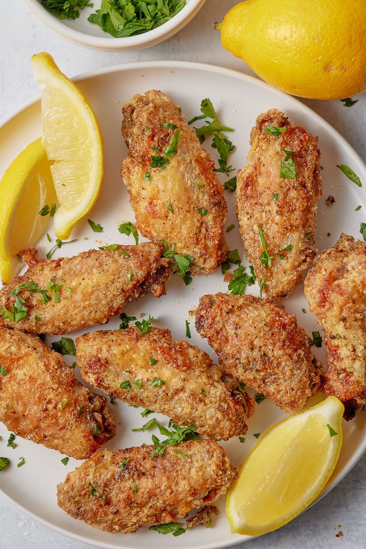 Lemon pepper chicken wings garnished with fresh parsley.