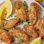 Lemon pepper chicken wings garnished with fresh parsley.