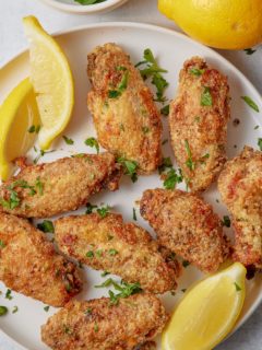 Lemon pepper chicken wings garnished with fresh parsley.