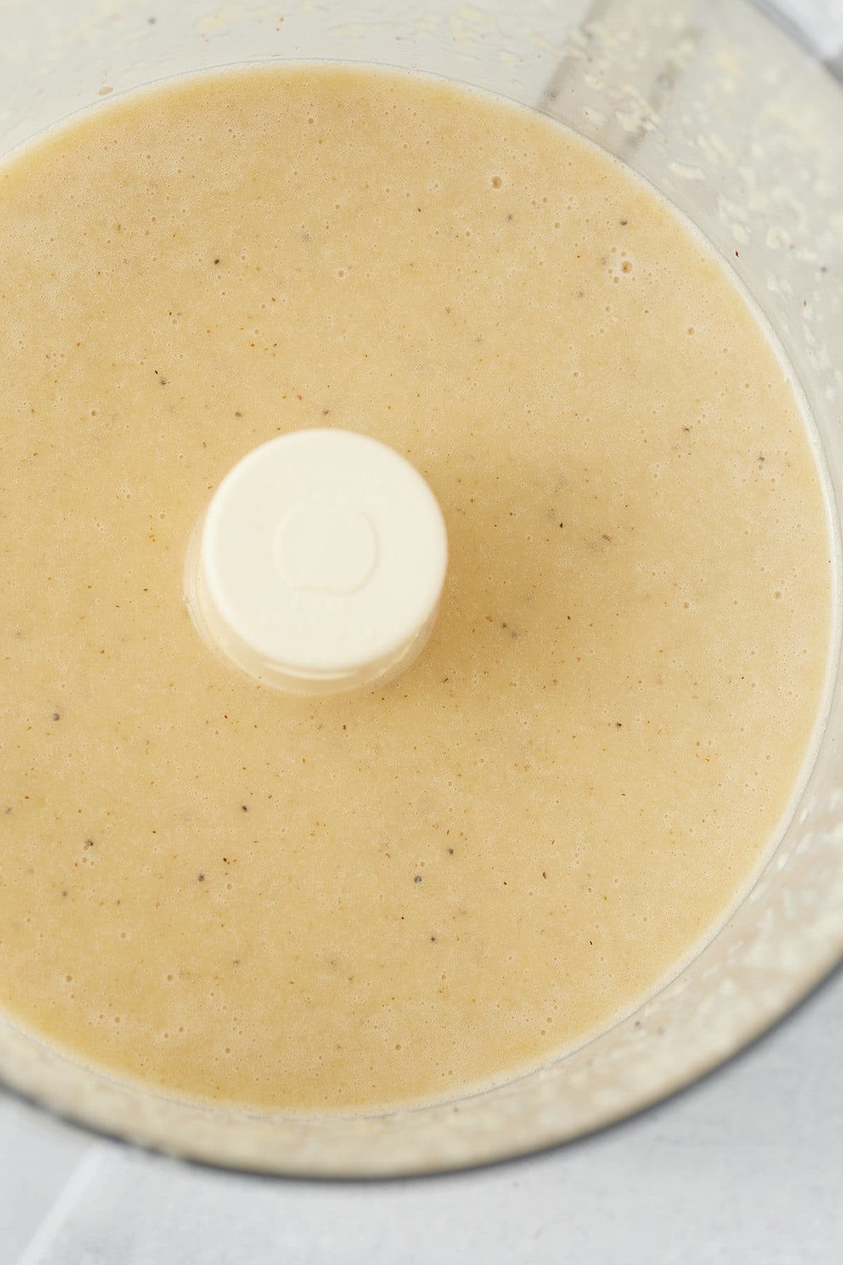 The dressing in the food processor once the oil has been added.