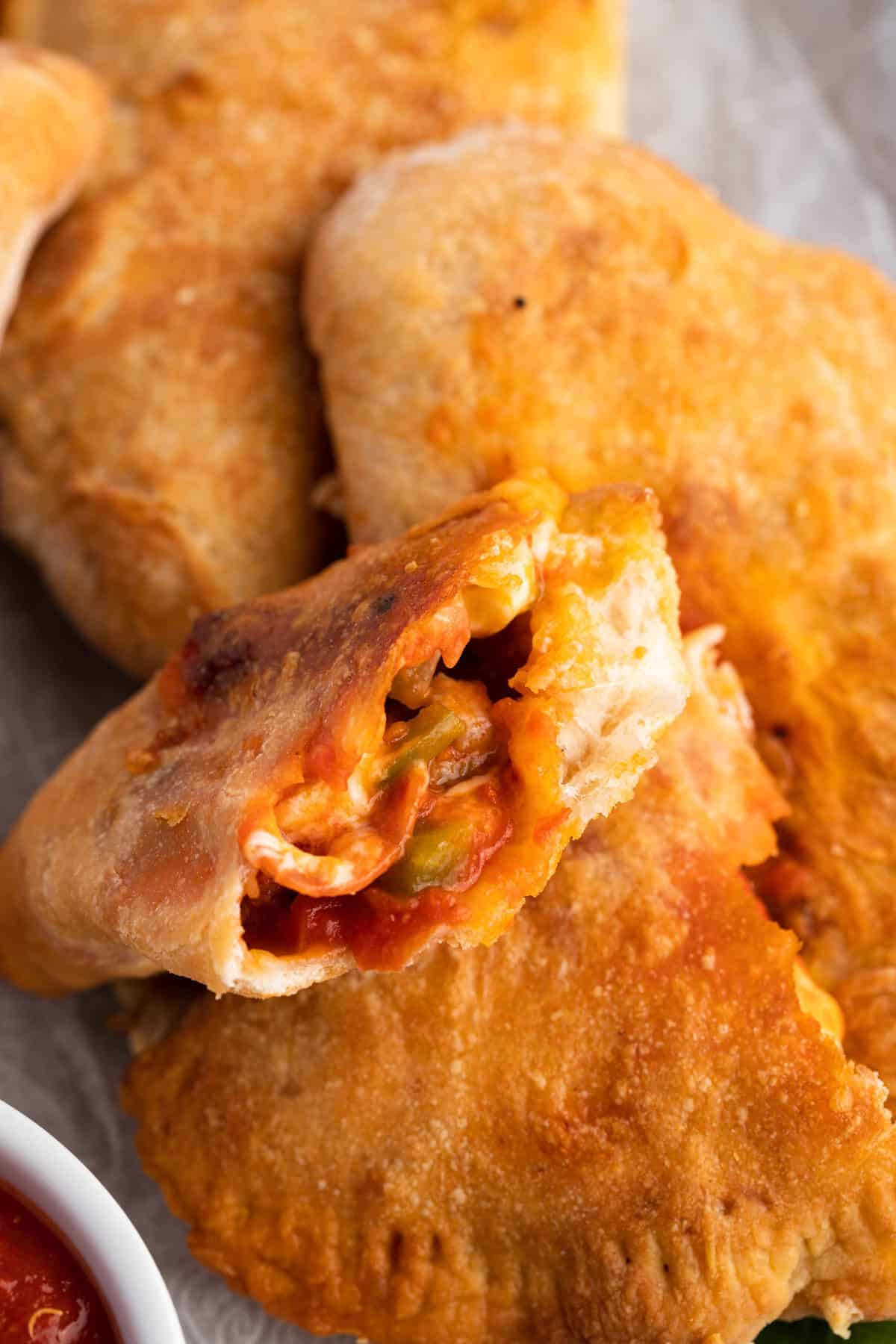 air fryer calzones broken open to see nside with filling