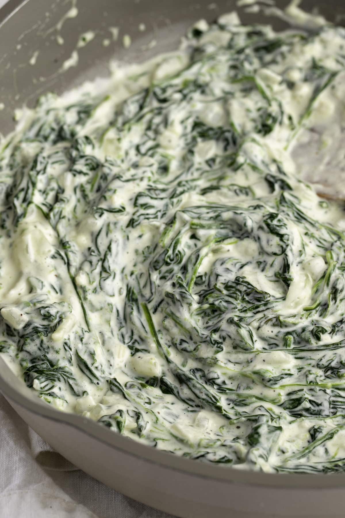 Close up of the creamed spinach in a skillet ready to serve.