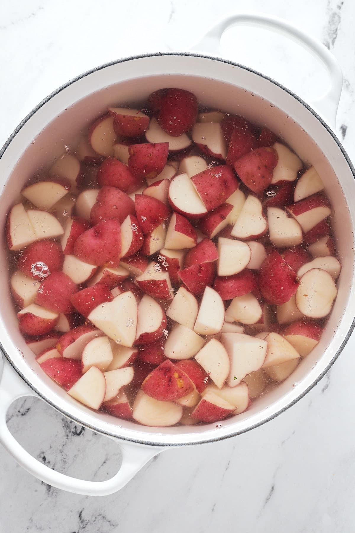 Chopped potatoes in a pot of water.