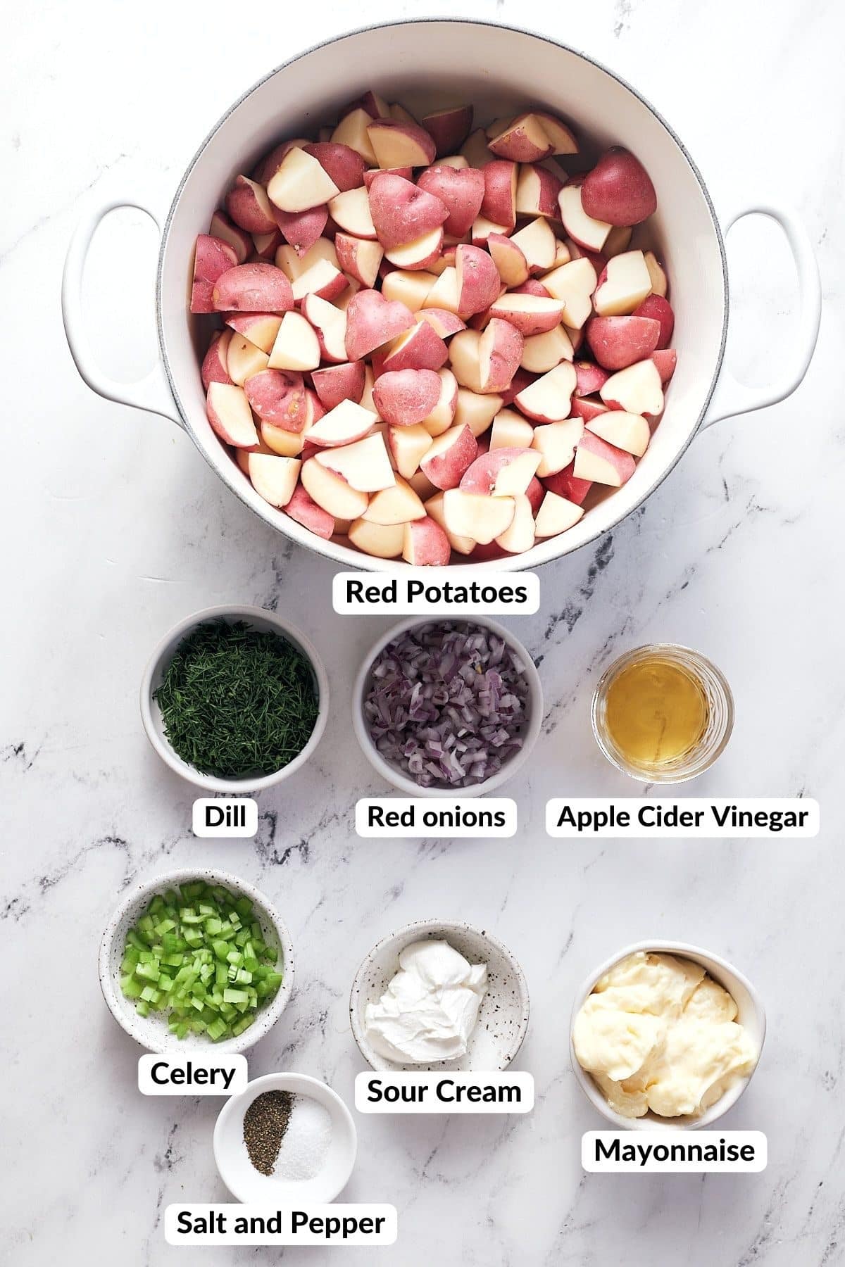 ingredients for dill potato salad laid on table with text naming each ingredient