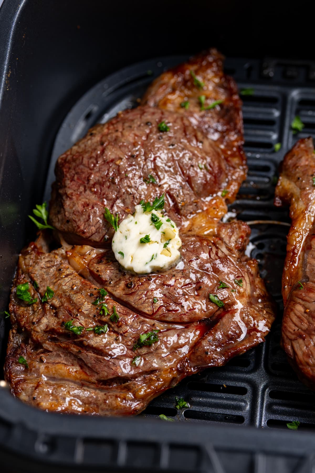 cooked steak in air fryer basket