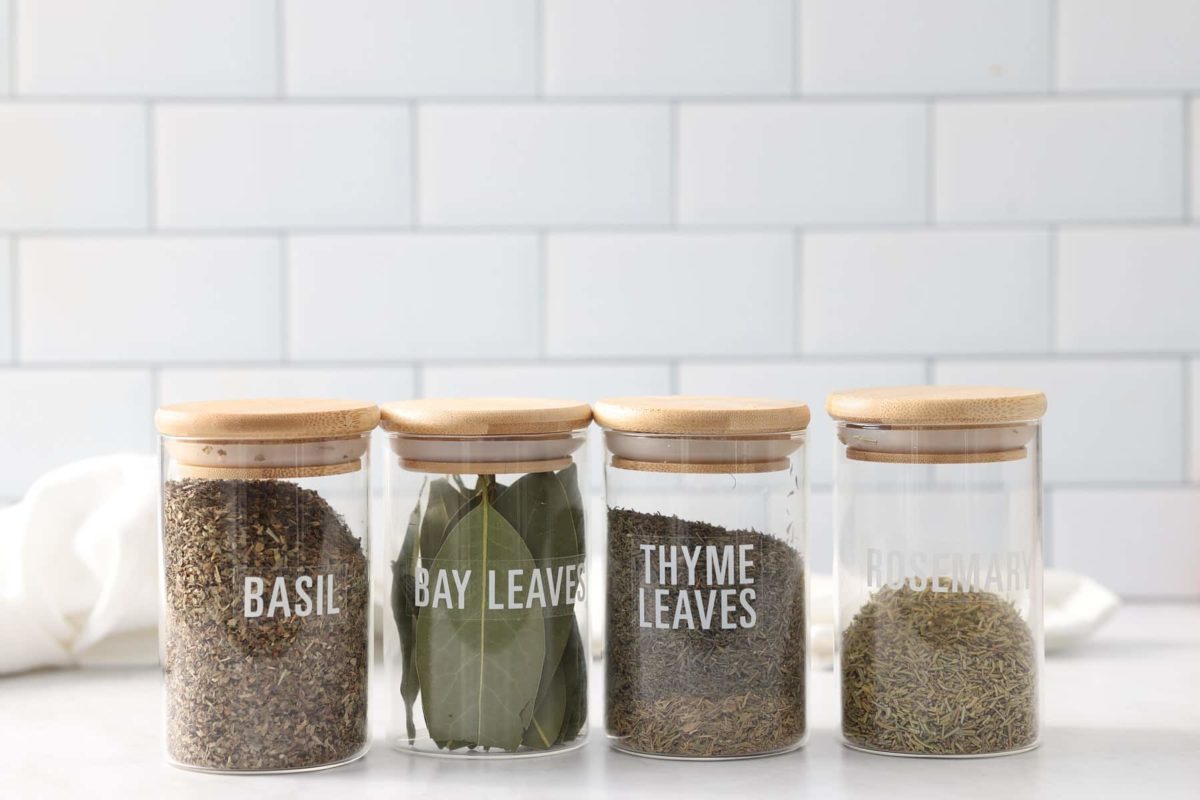 dried herbs in front of white tile background