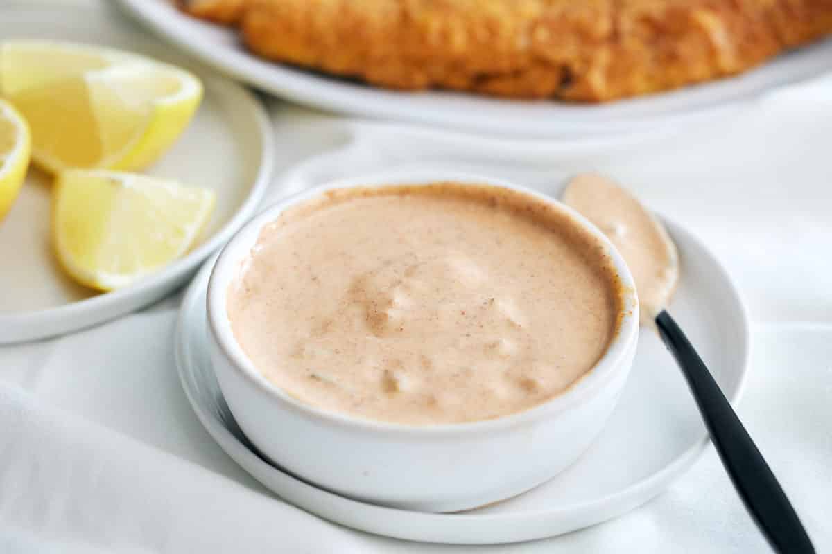 remoulade sauce in white bowl on white plate