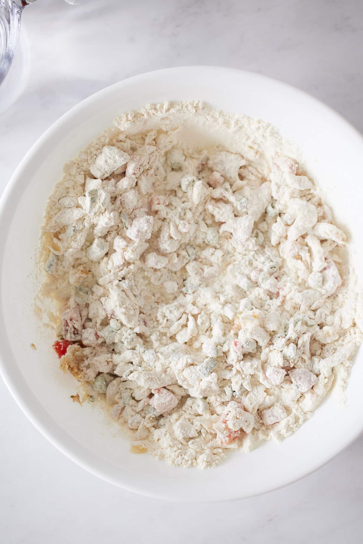 dry ingredients mixed for saltfish fritters in white bowl