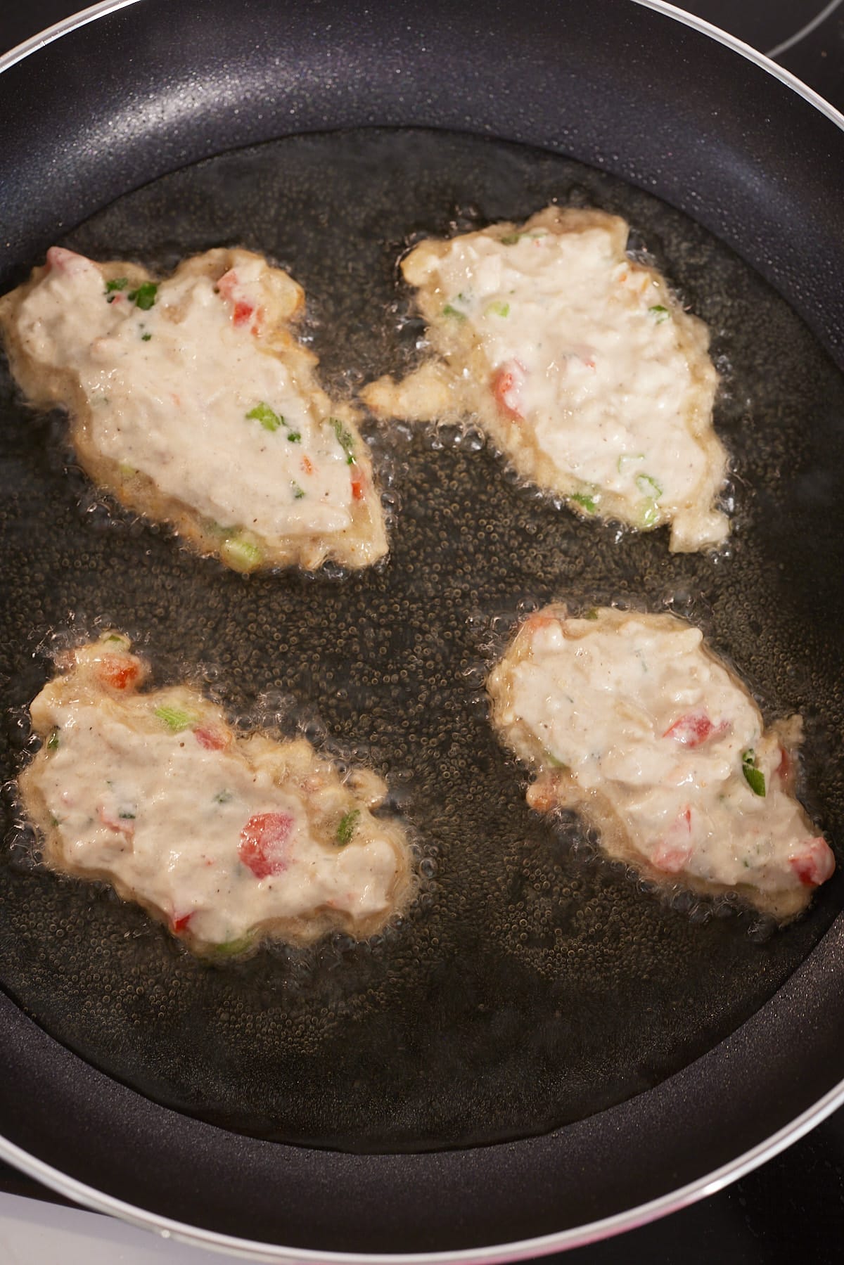 saltfish fritters frying in pan