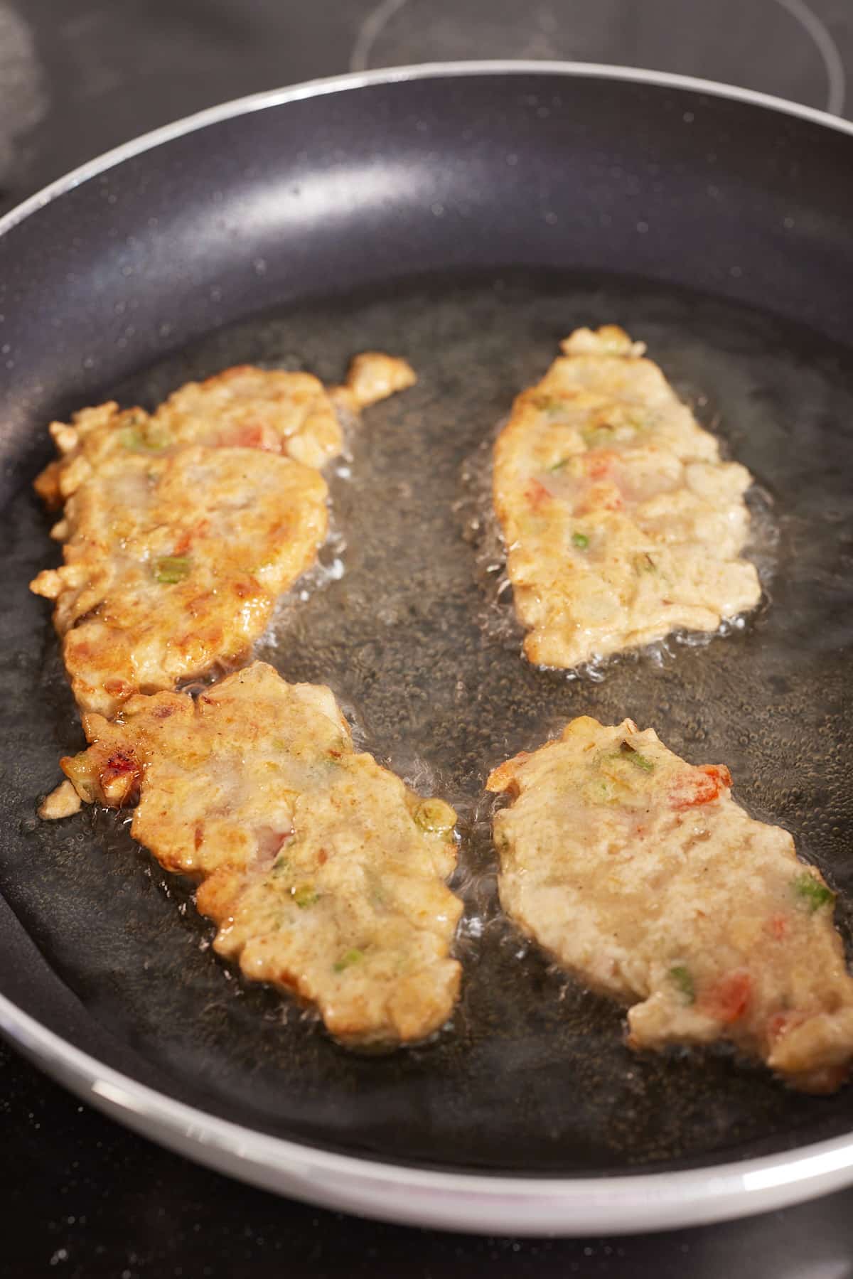 fritters frying in pan
