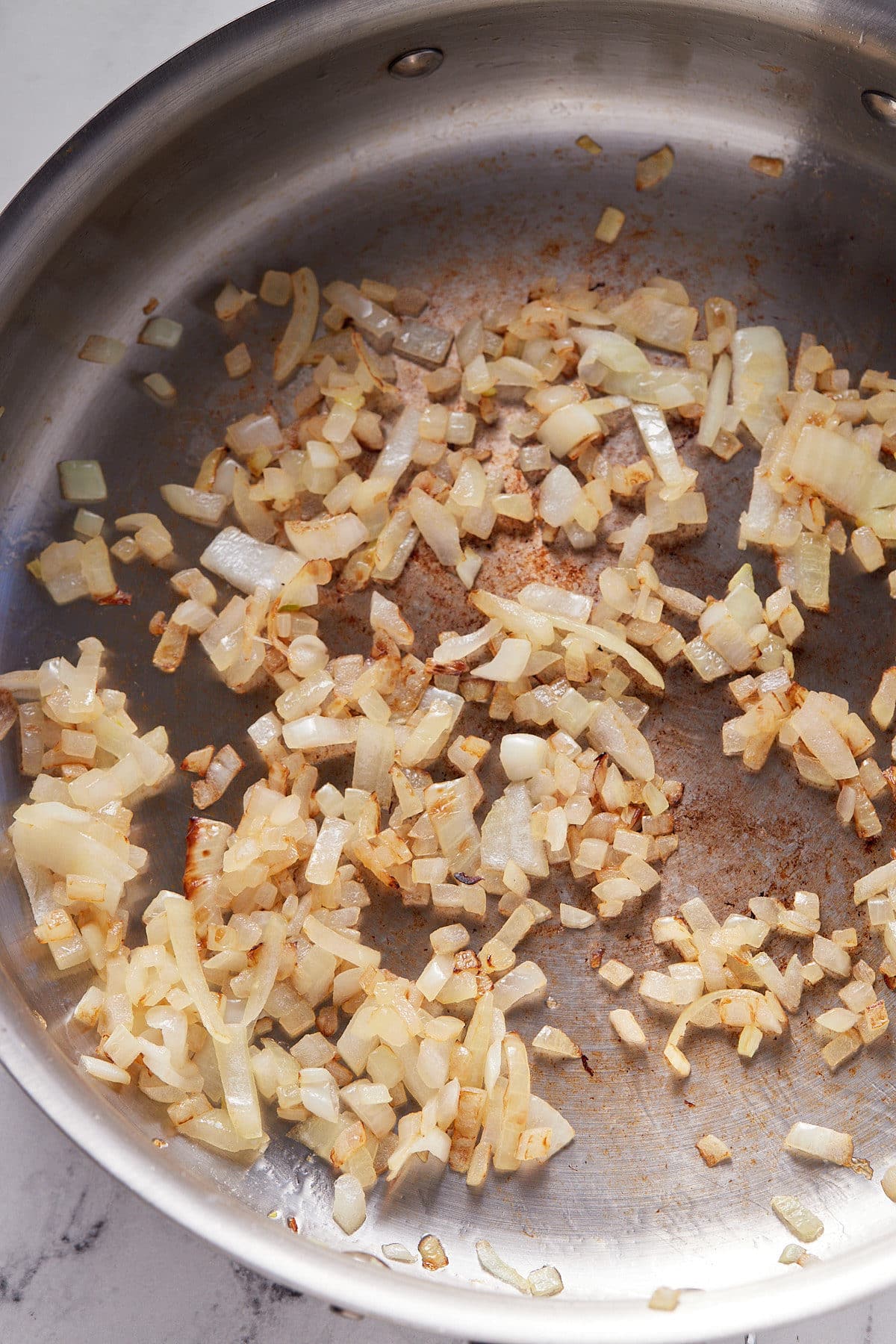 Cooking garlic and onions in a skillet.