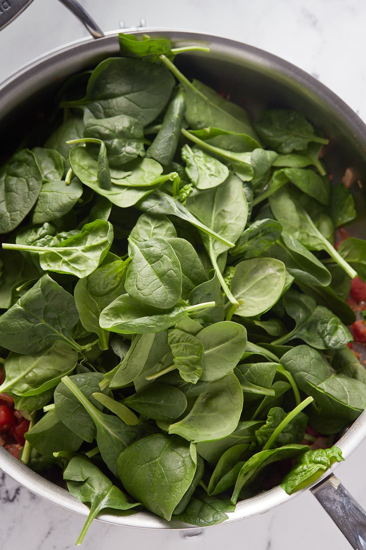 Spinach added to the skillet.