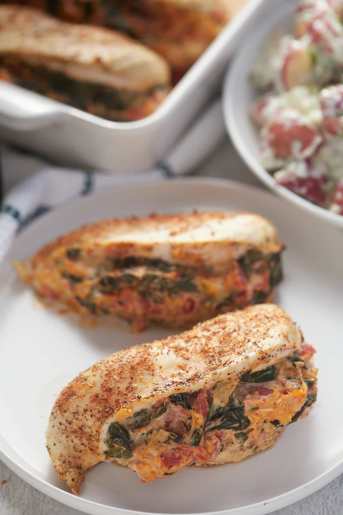 Two chicken breasts stuffed with spinach, tomatoes and cream cheese.
