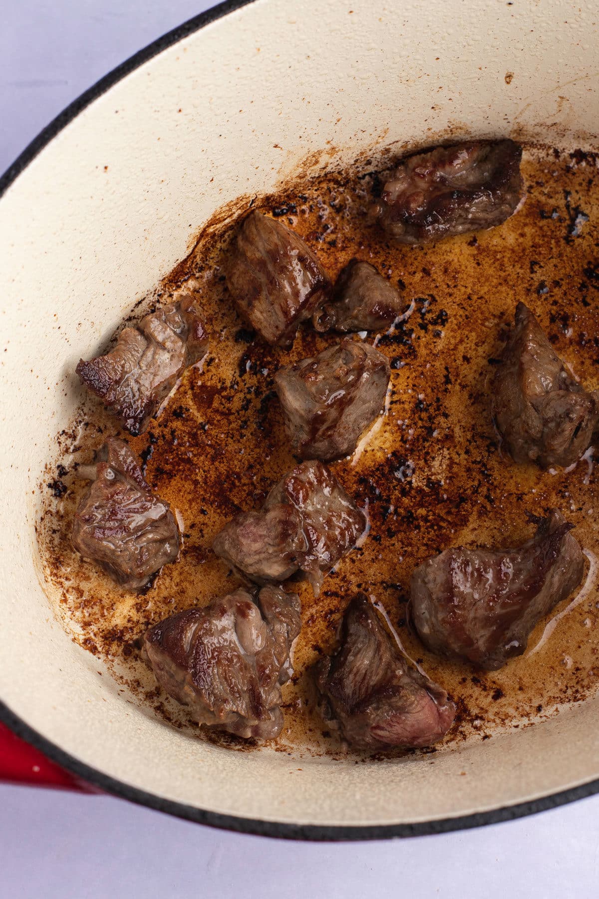 Browning the beef cubes.