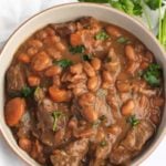 Overhead shot of a bowl of beef and bean stew.