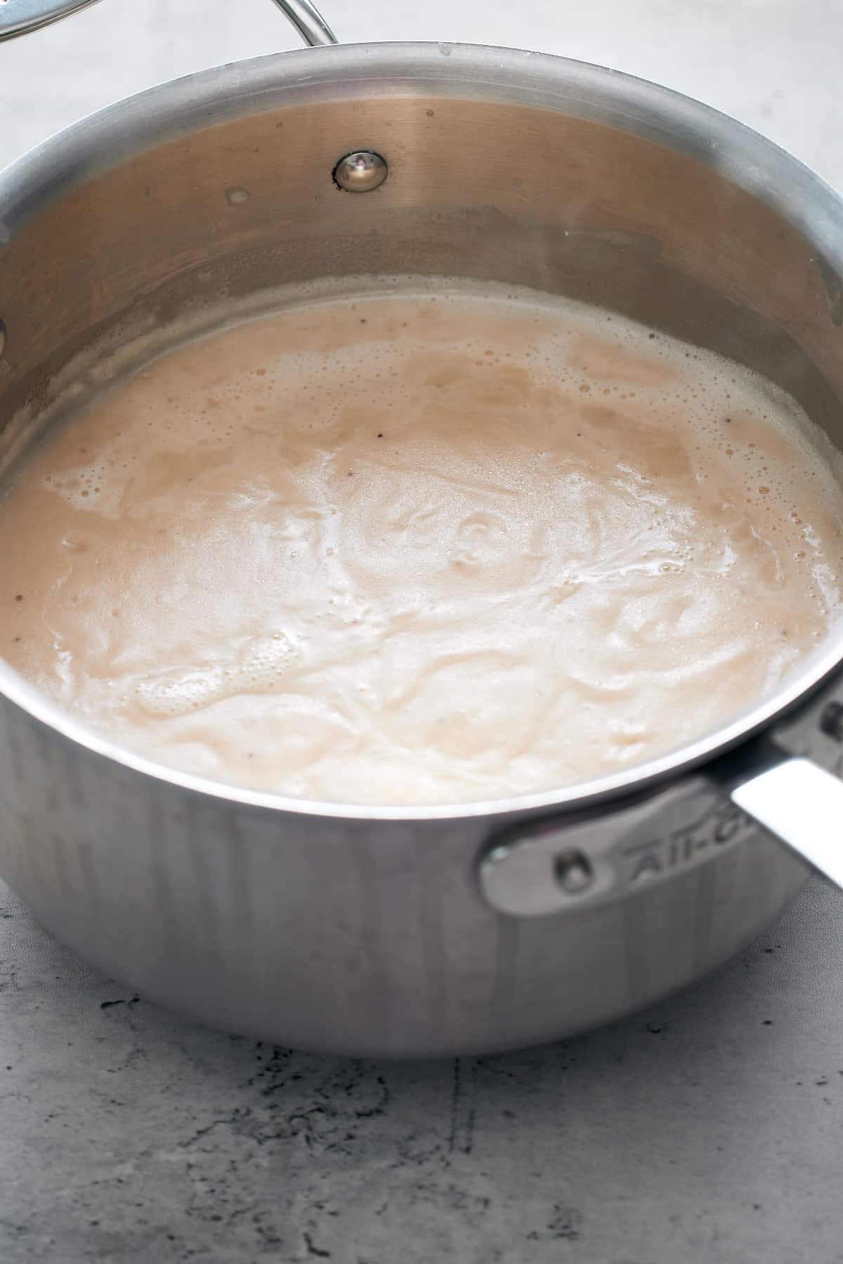 green banana porridge boiling in pot