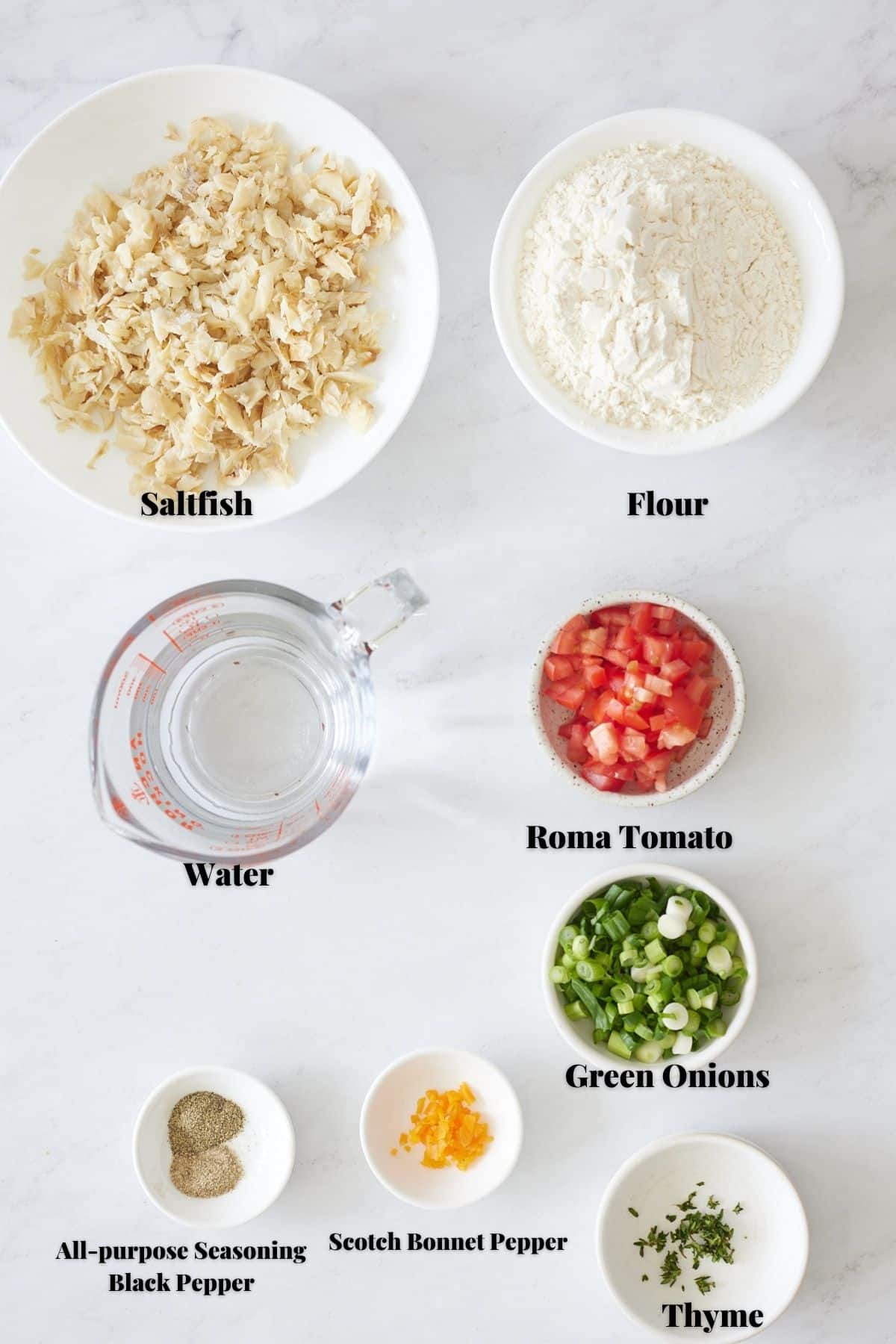 ingredients for saltfish fritters on white background