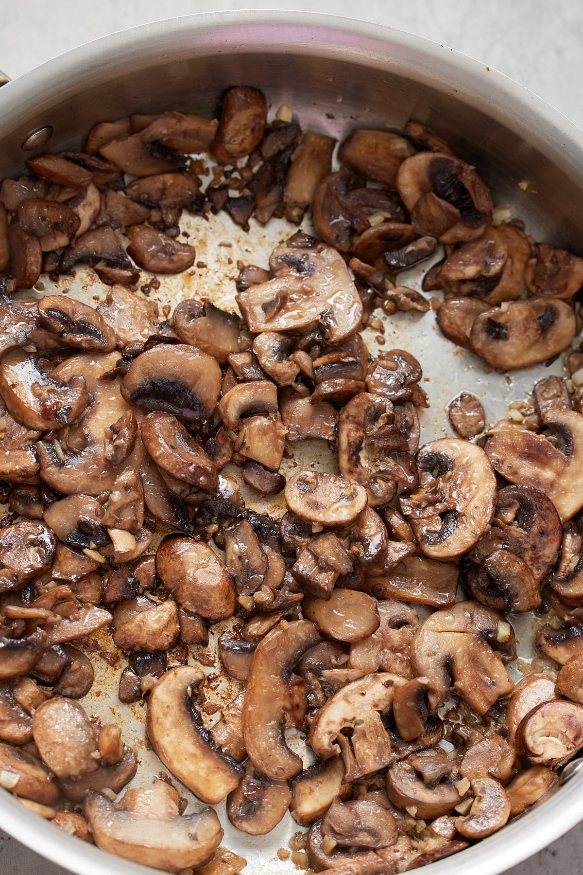 Sautéing mushrooms in a skillet.