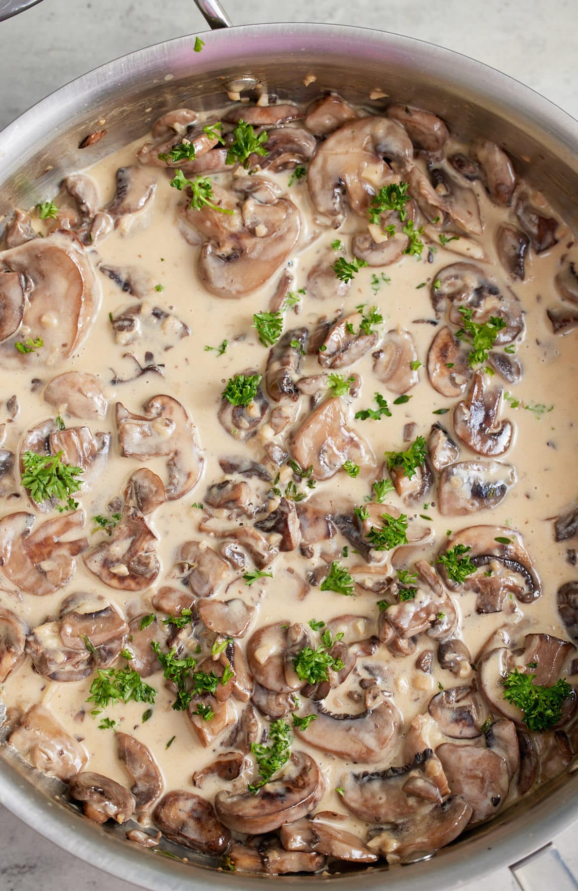 Creamy mushroom sauce garnished with fresh parsley.