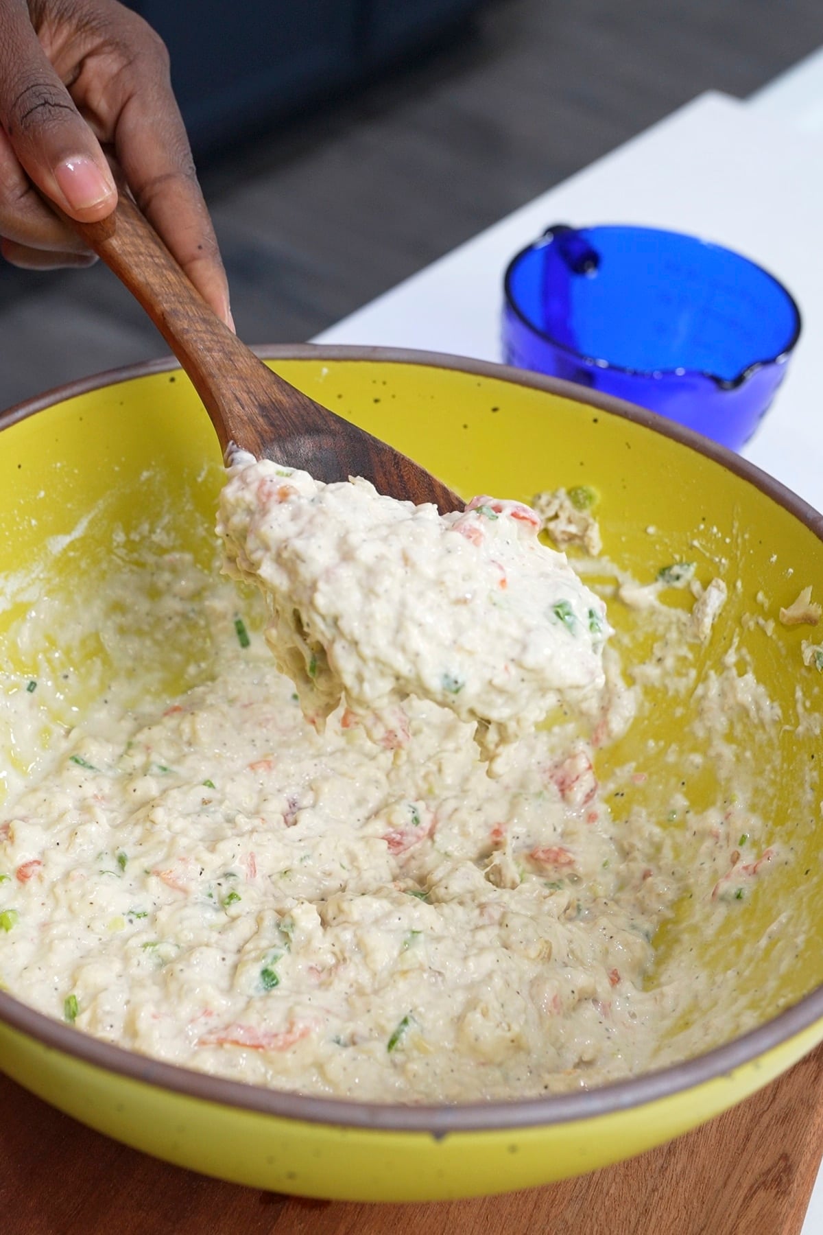 saltfish batter pouring off spoon