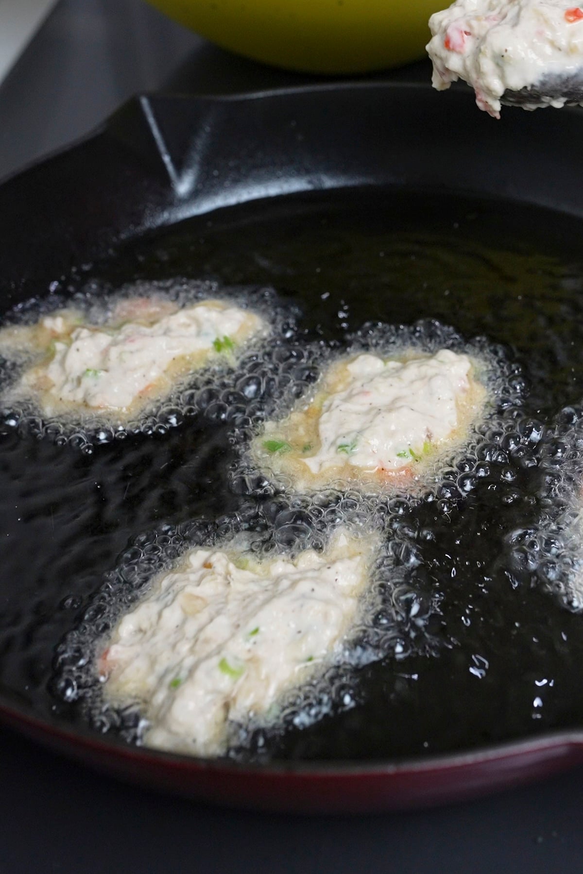saltfish frying on stove in oil