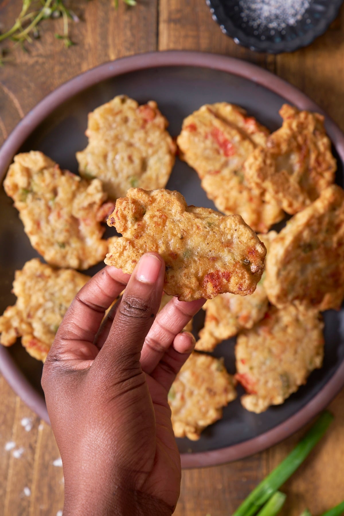 hand holding up saltfish fritter