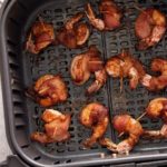 finished air fryer bacon wrapped shimp in air fryer basket