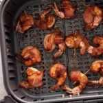 finished air fryer bacon wrapped shimp in air fryer basket