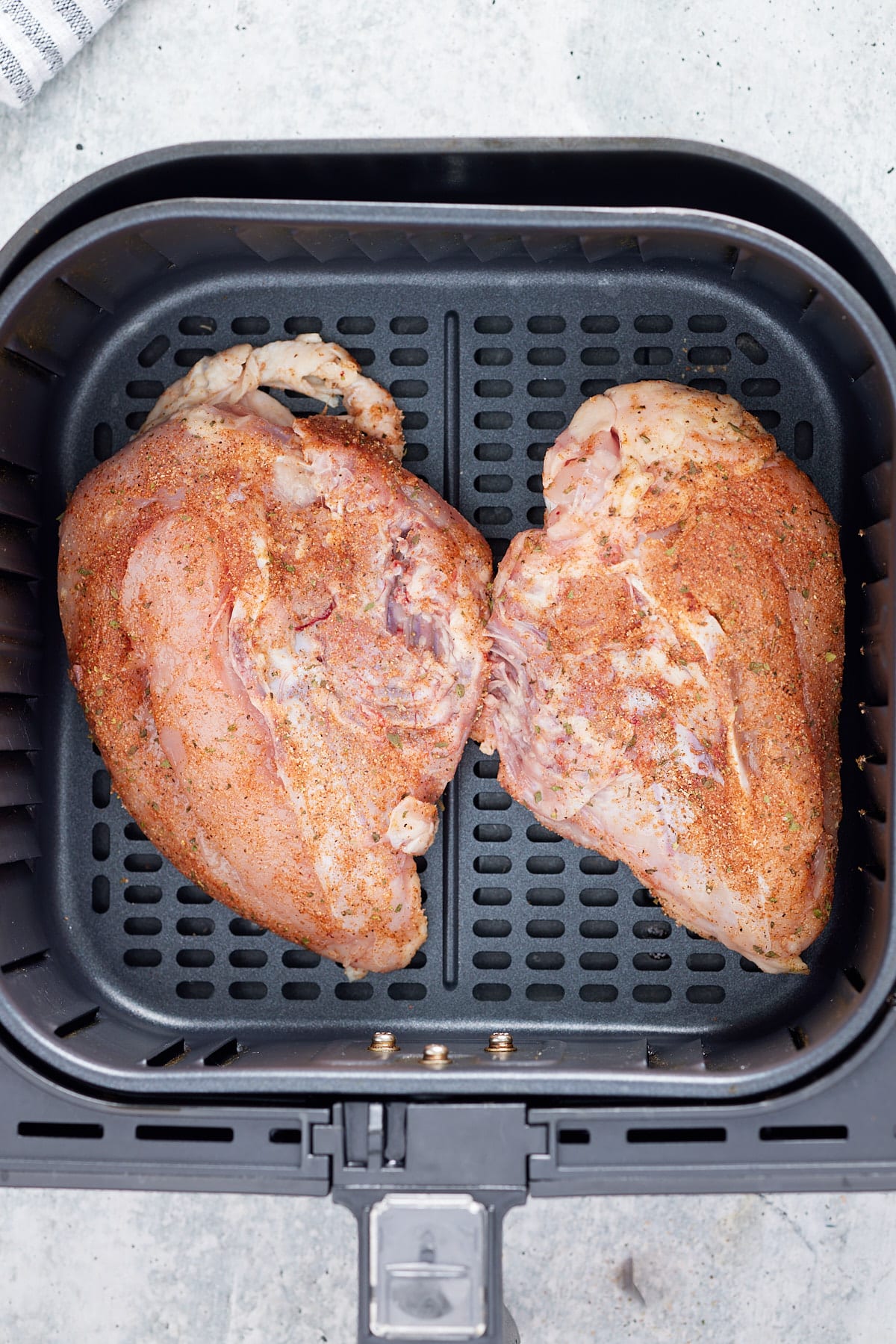 split bone-in chicken breasts in air fryer basket