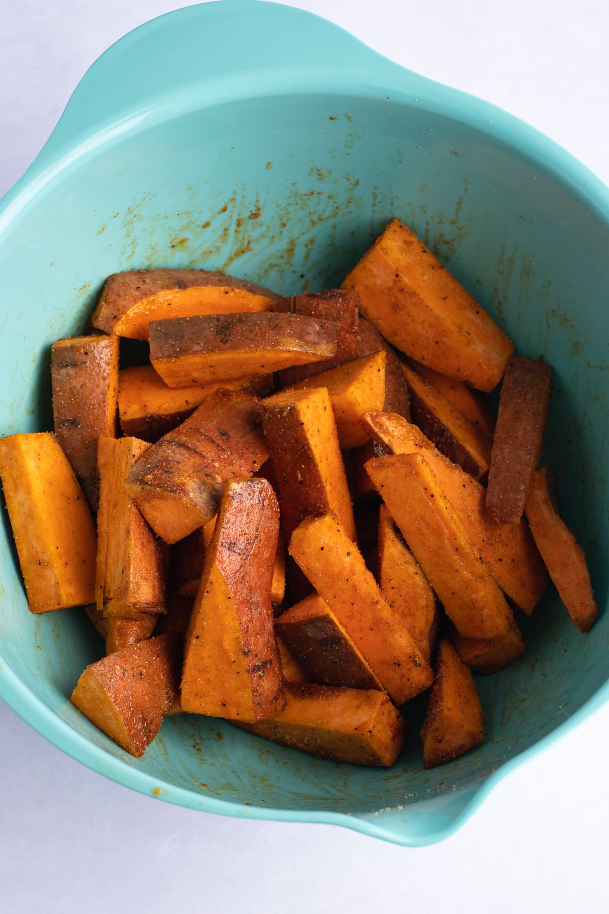 Cut sweet potato tossed in the seasoning.