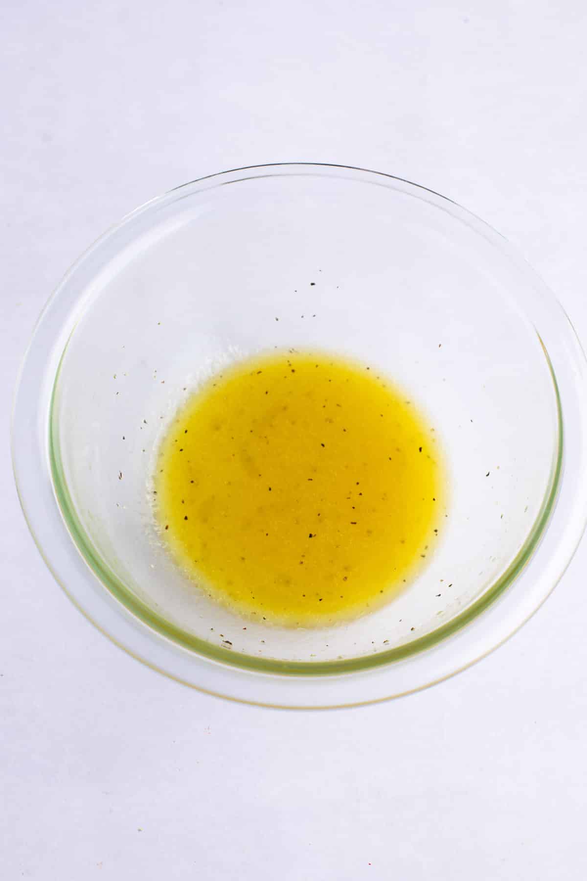 The salad dressing in a glass bowl.