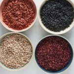 plates of dried beans on white background