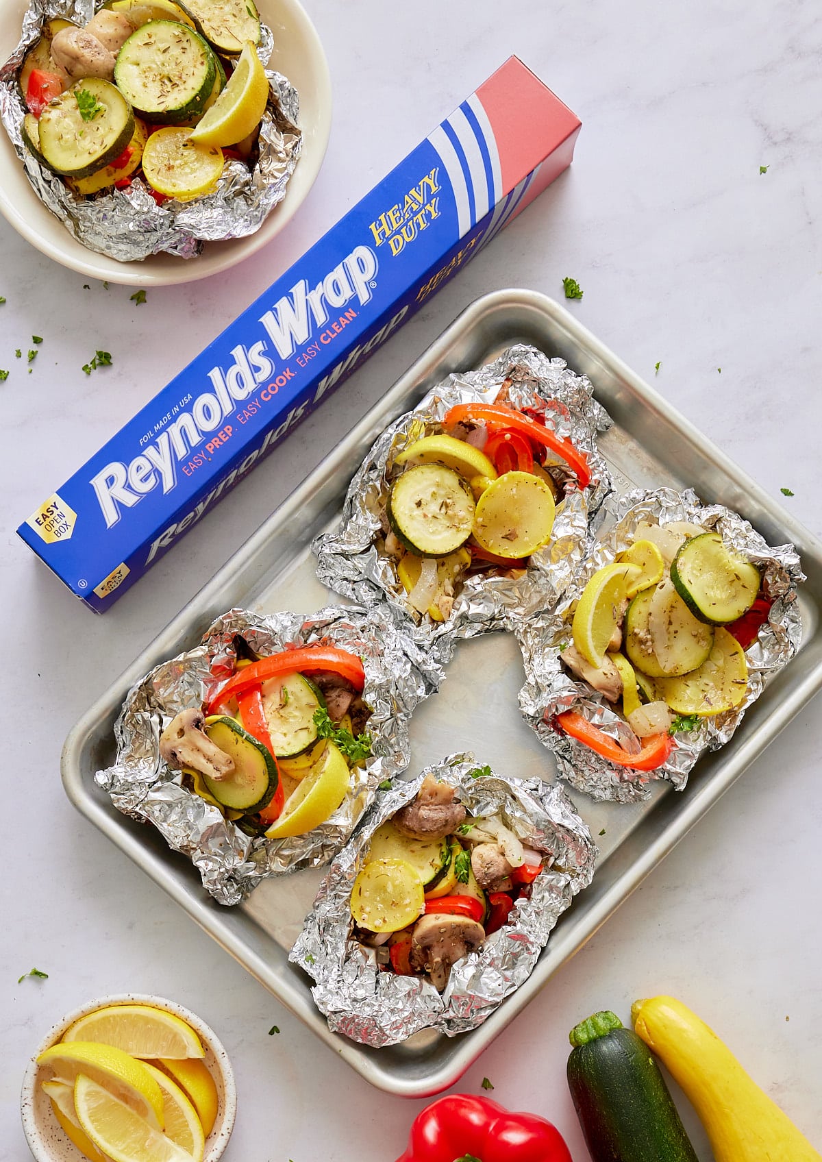 grilled marinated vegeatbles on a sheet pan lined with heavy duty foil