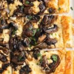 A mushroom tart cut into squares to serve.