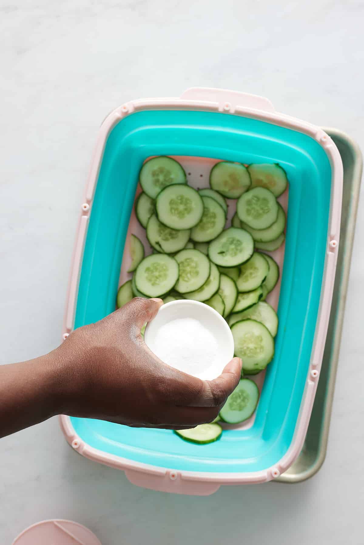 Salting the cucumbers.