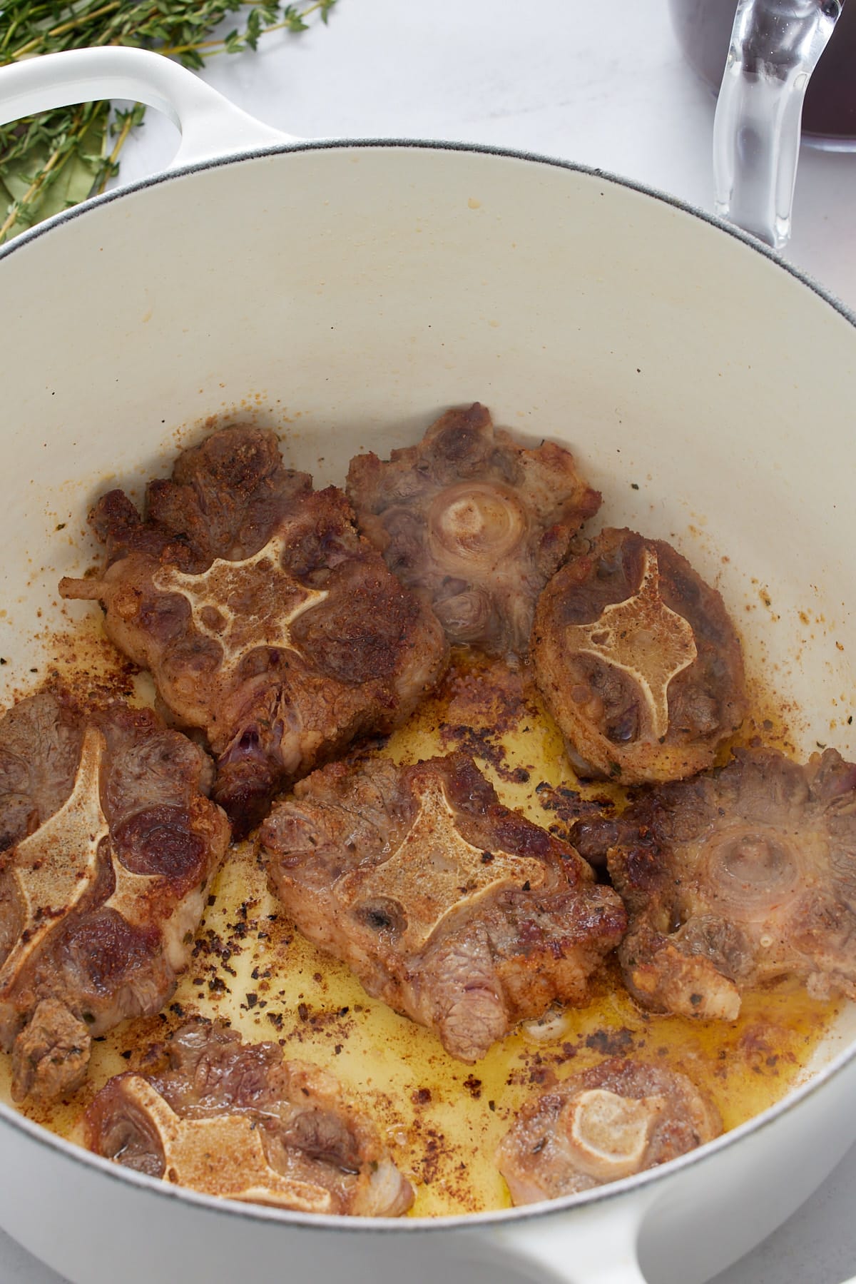 oxtails browning in white pot
