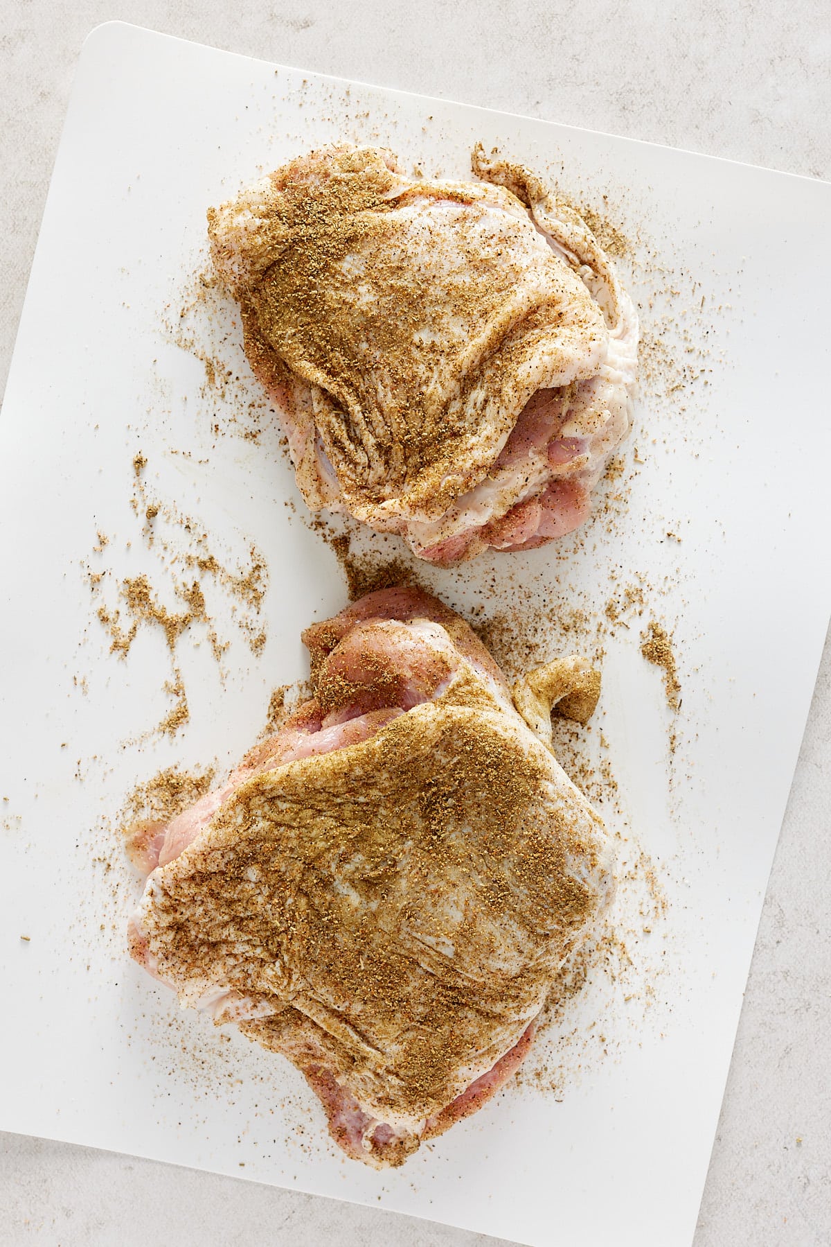 raw turkey thighs rubbed with seasoning blend