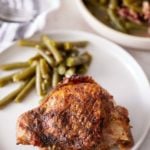 plate of green beans and a chicken thigh