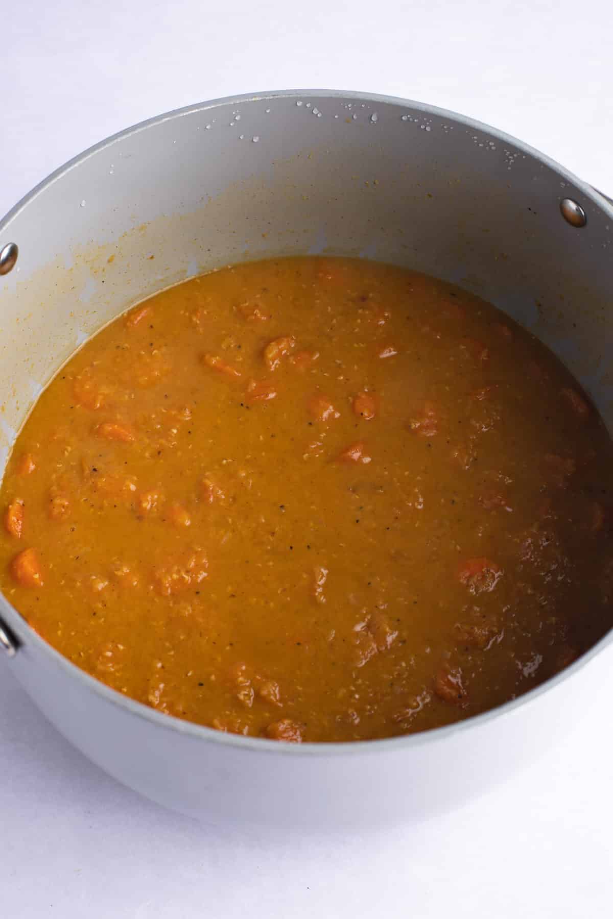 vegetable broth and lentils added to a large pot