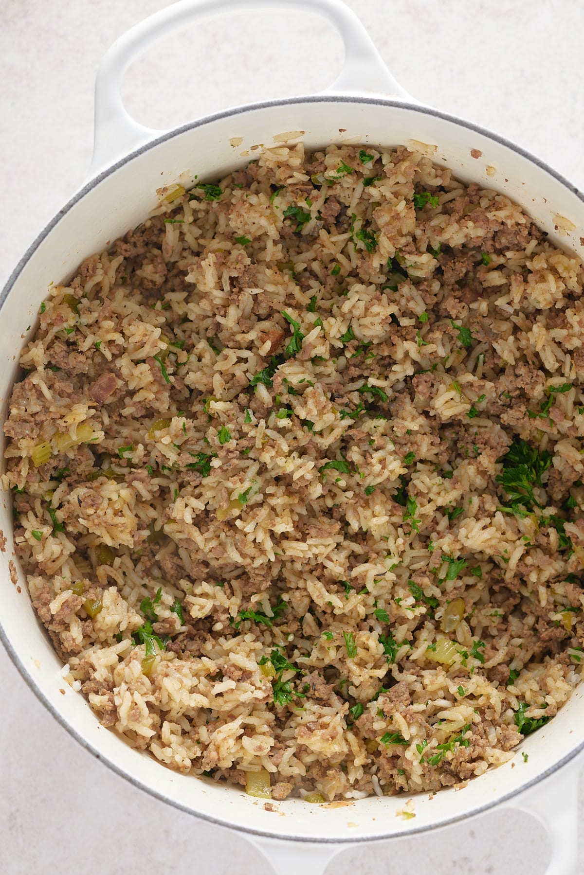 finished pot of dirty rice with fresh parsley on top