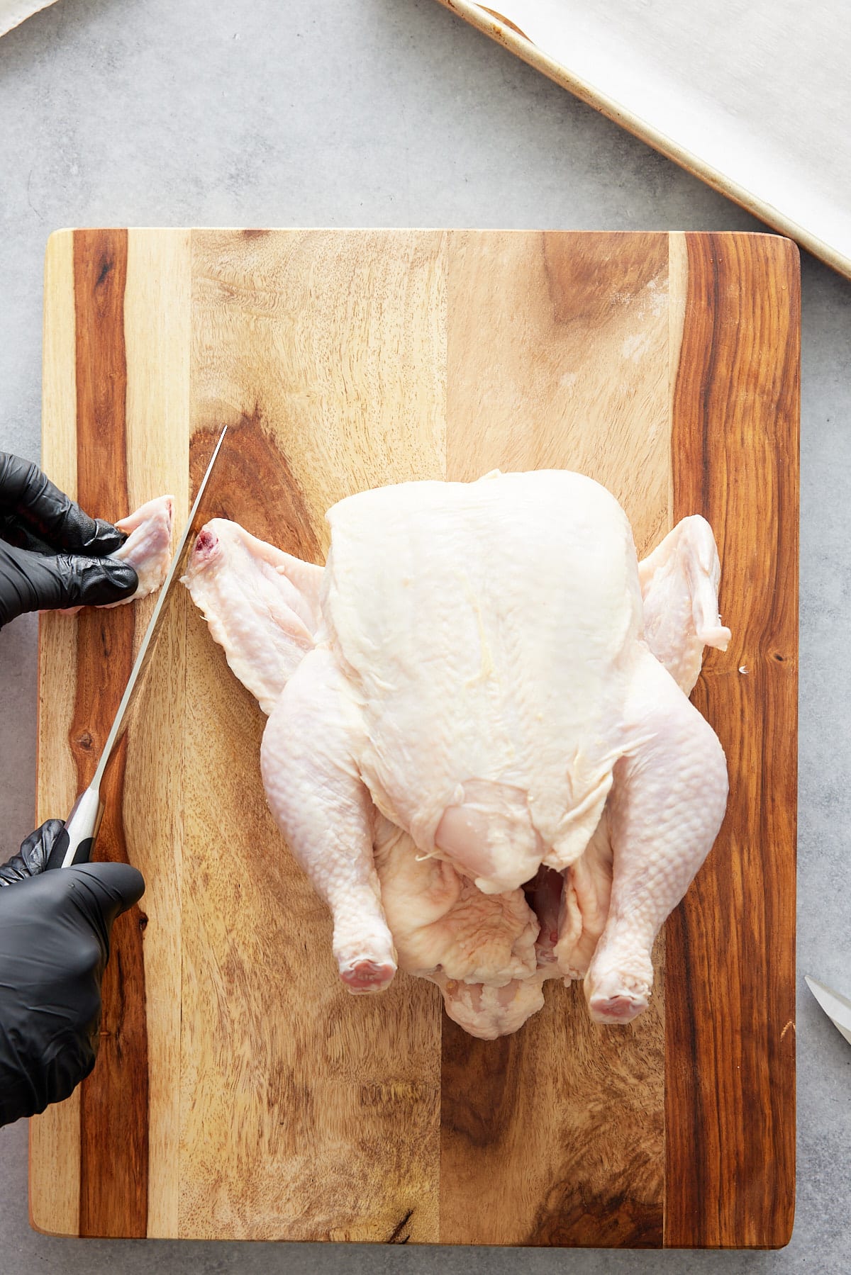 cutting wing tips away from chicken