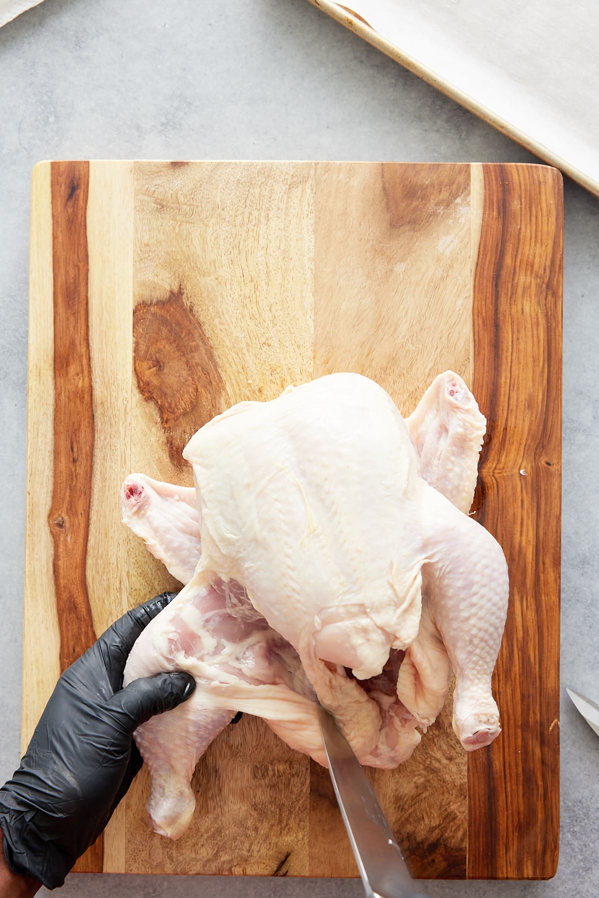 chicken leg being cut off