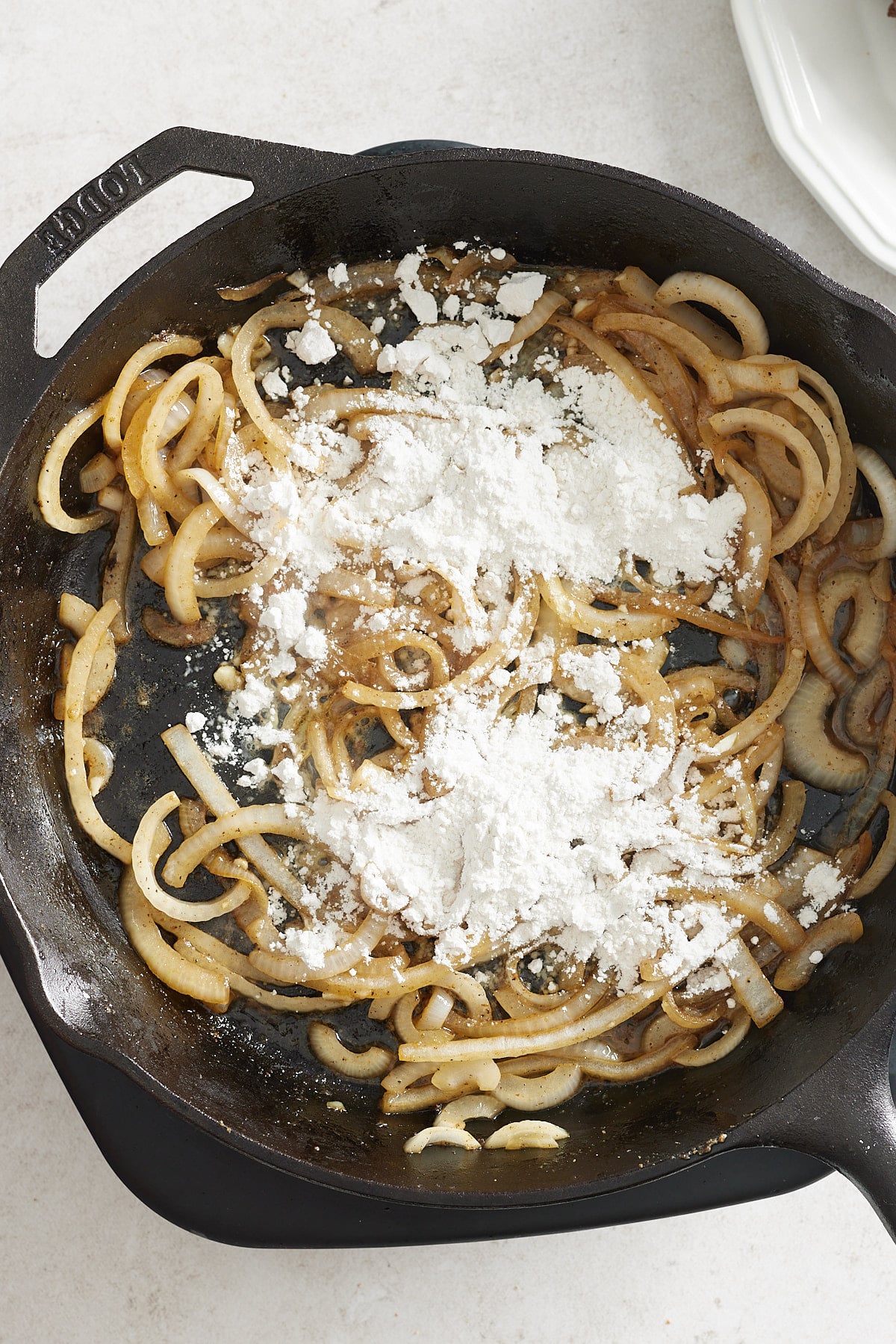 onions and flour in a cast iron pan