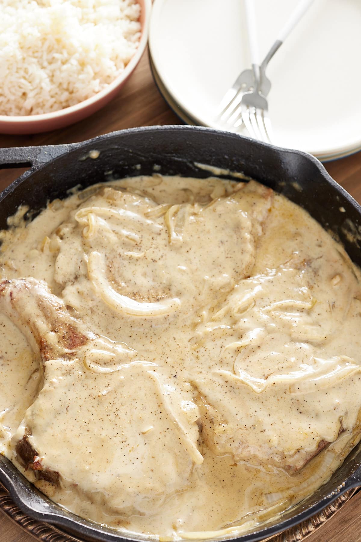 pork chops in a cast iron pan ready to be served