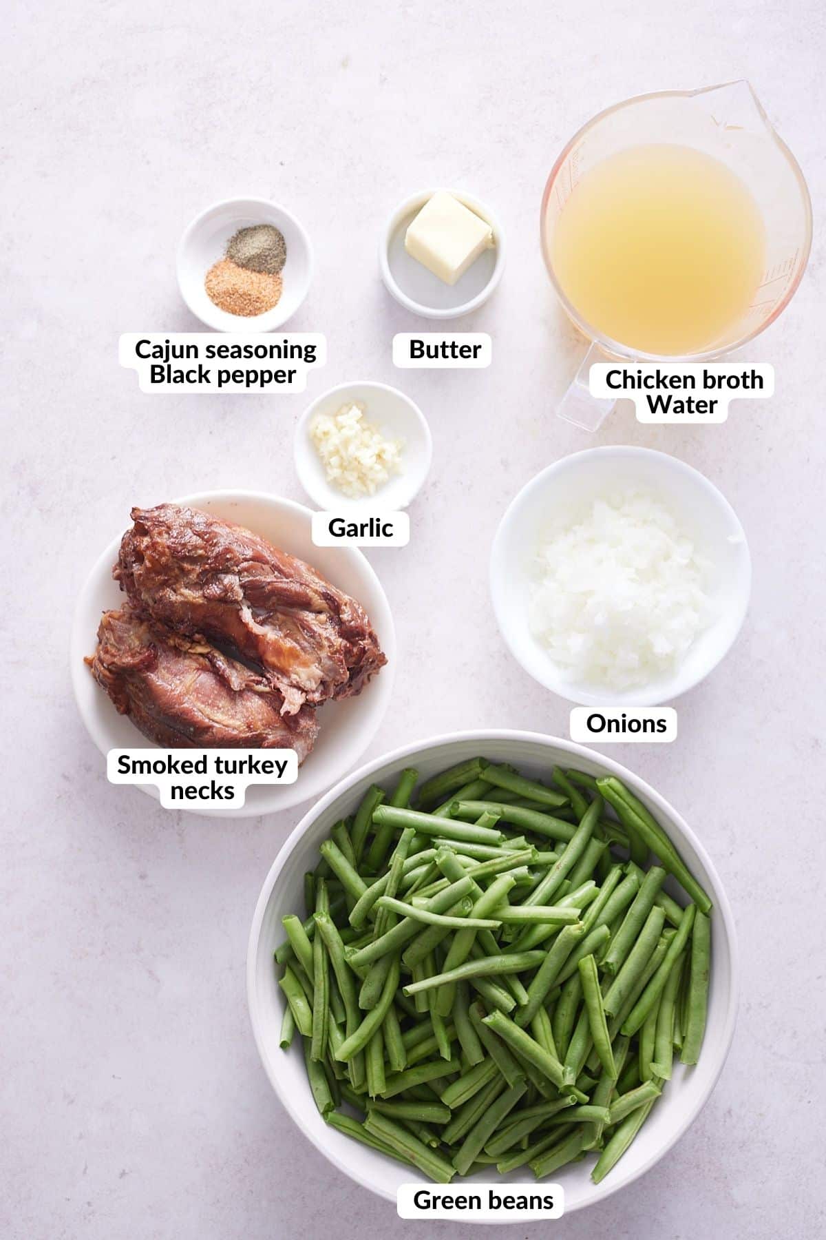 ingredients for southern green beans in small dishes on a white background